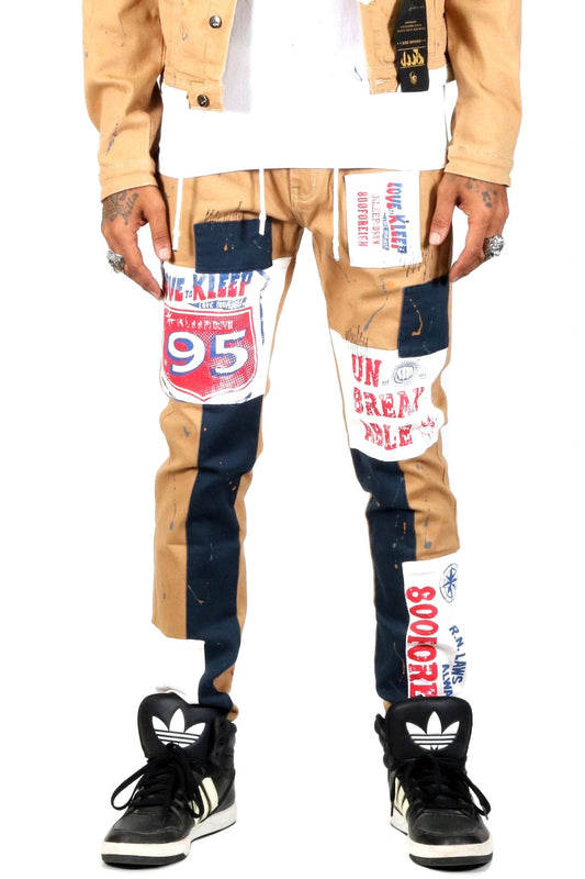 Pantalones ajustados de sarga elástica de algodón lavado con efecto madera, cortados y cosidos, con parches estampados gráficos de Antelope para hombre
